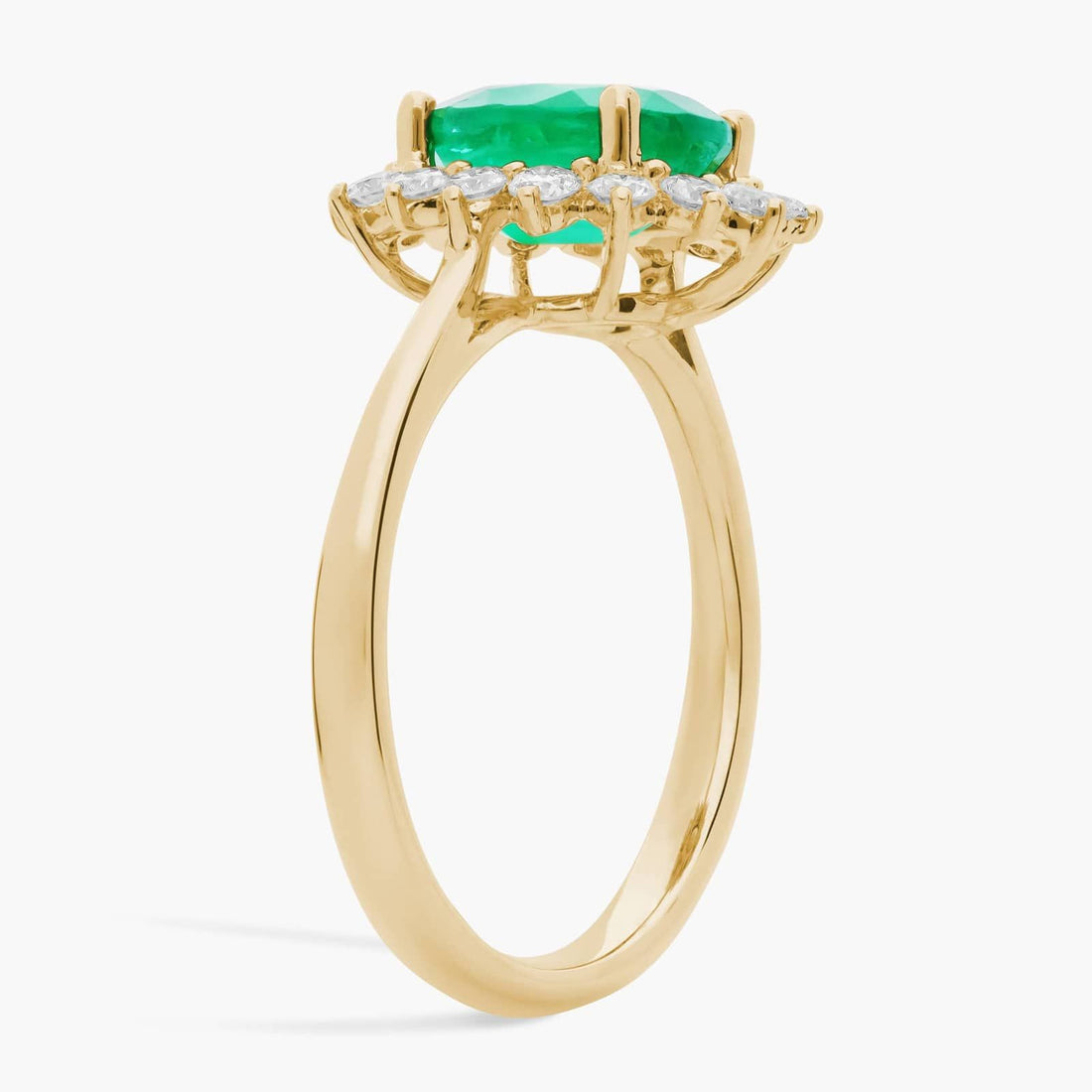 Oval Emerald and Diamond Sunburst Halo Ring in Yellow Gold