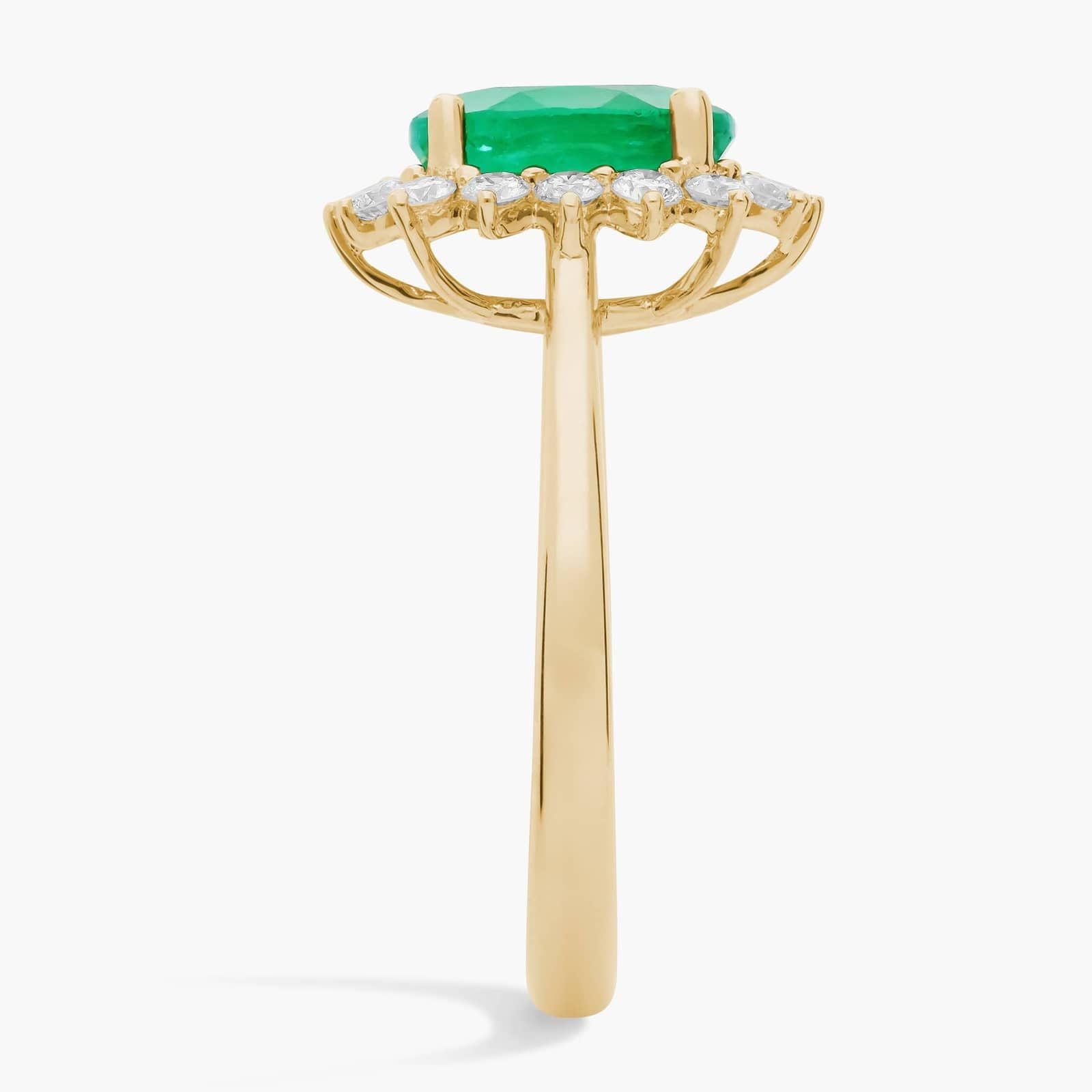 Oval Emerald and Diamond Sunburst Halo Ring in Yellow Gold