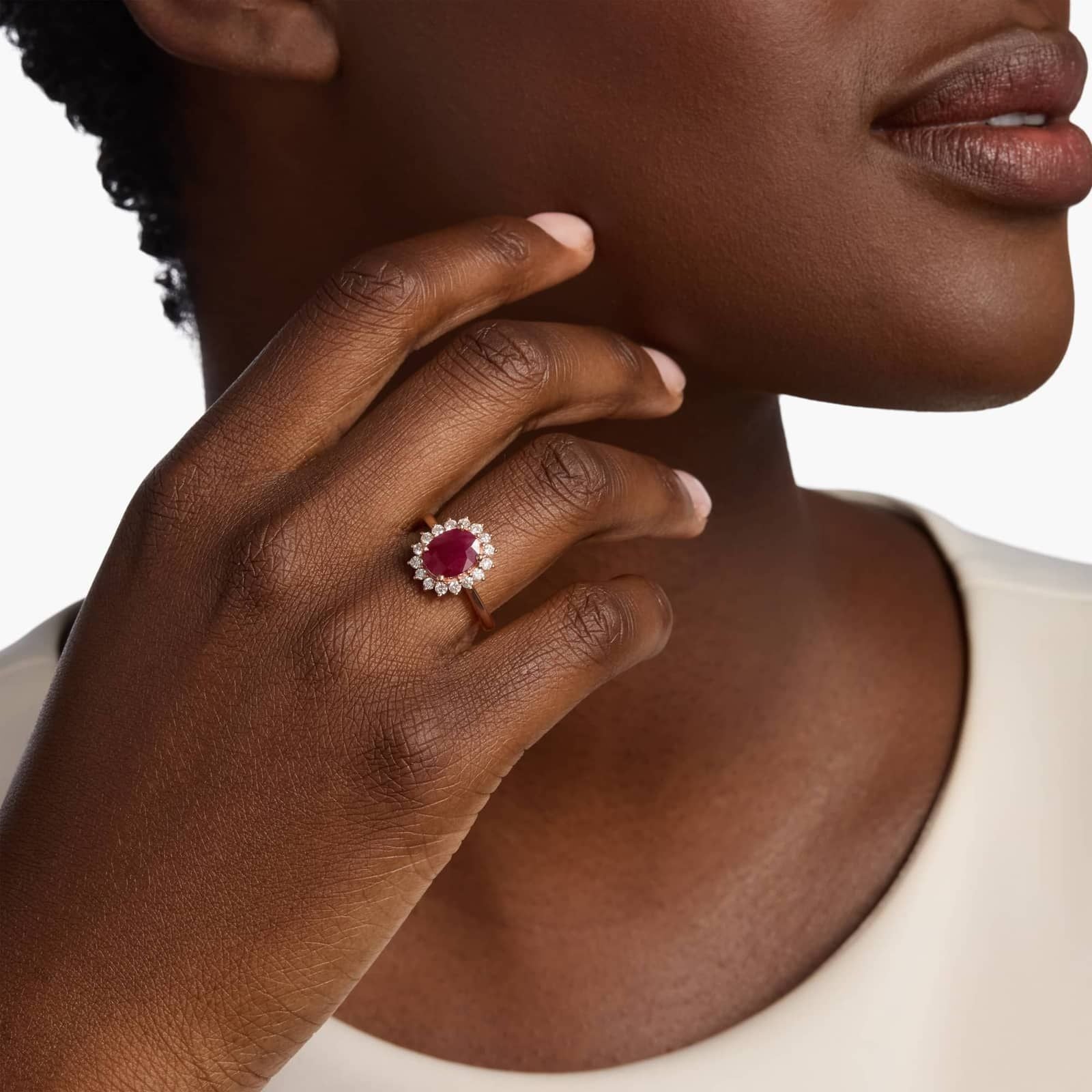 Oval Ruby and Diamond Sunburst Halo Ring in Rose Gold