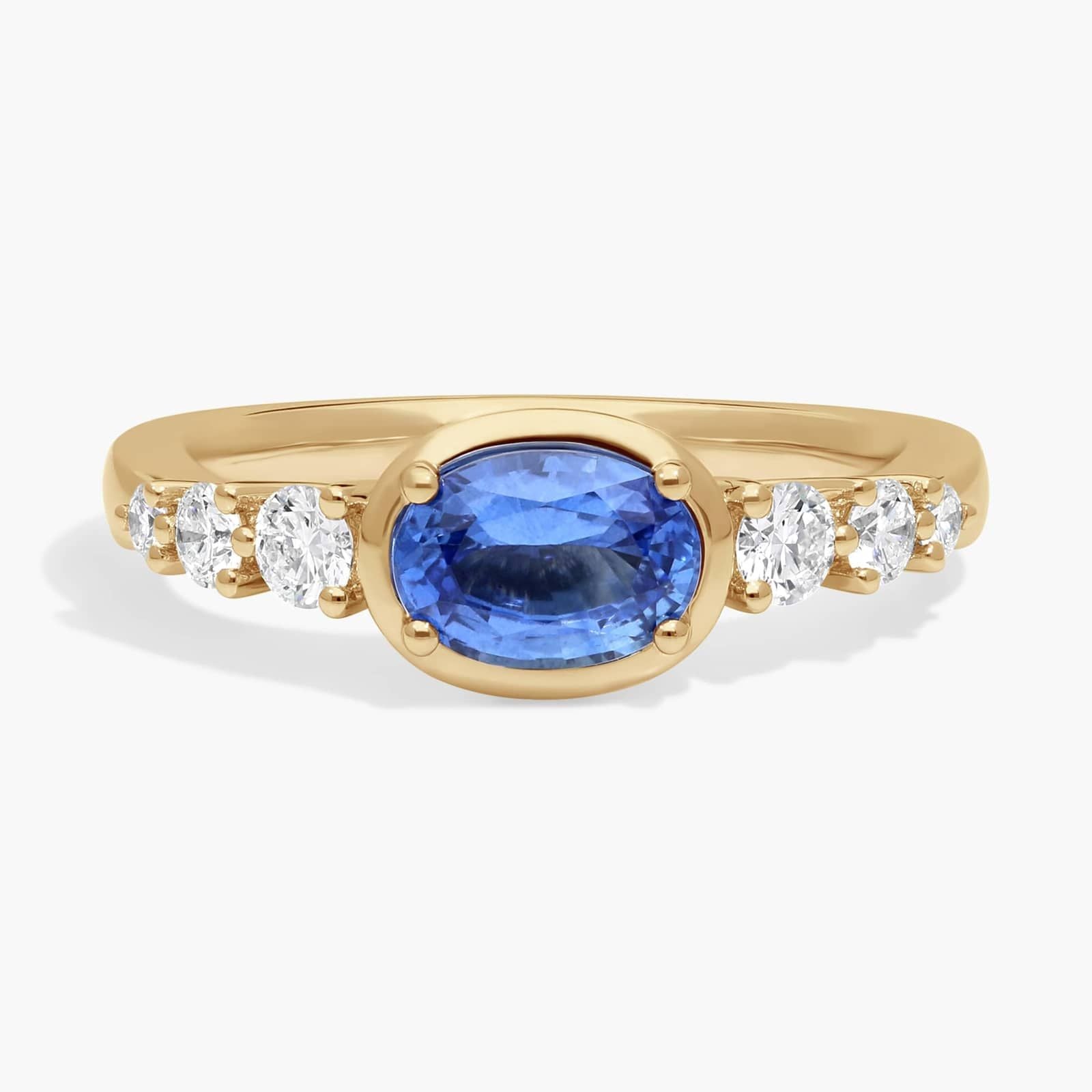 East-West Oval Cut Sapphire Ring With Half Bezel and Diamond Accent In White Gold / Yellow Gold