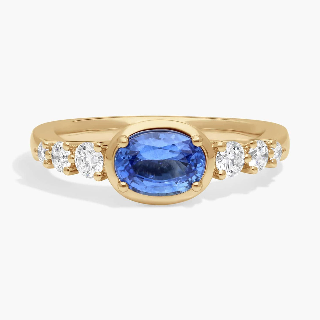 East-West Oval Cut Sapphire Ring With Half Bezel and Diamond Accent In White Gold / Yellow Gold